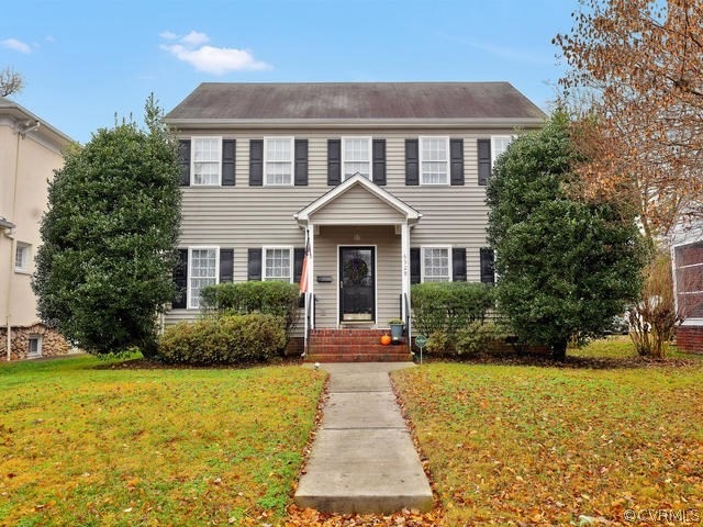 Front of home, concrete walkway from the City sidewalk, 5' x 7' covered front porch with aluminum railings, storm door, pendant style light fixture, mailbox
