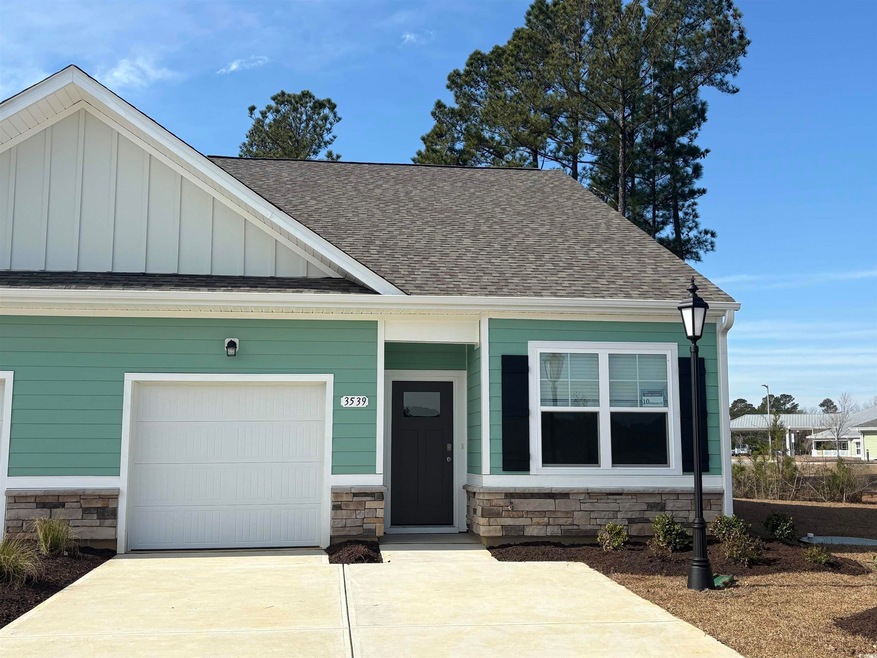 View of front of home with roof with shingles, con
