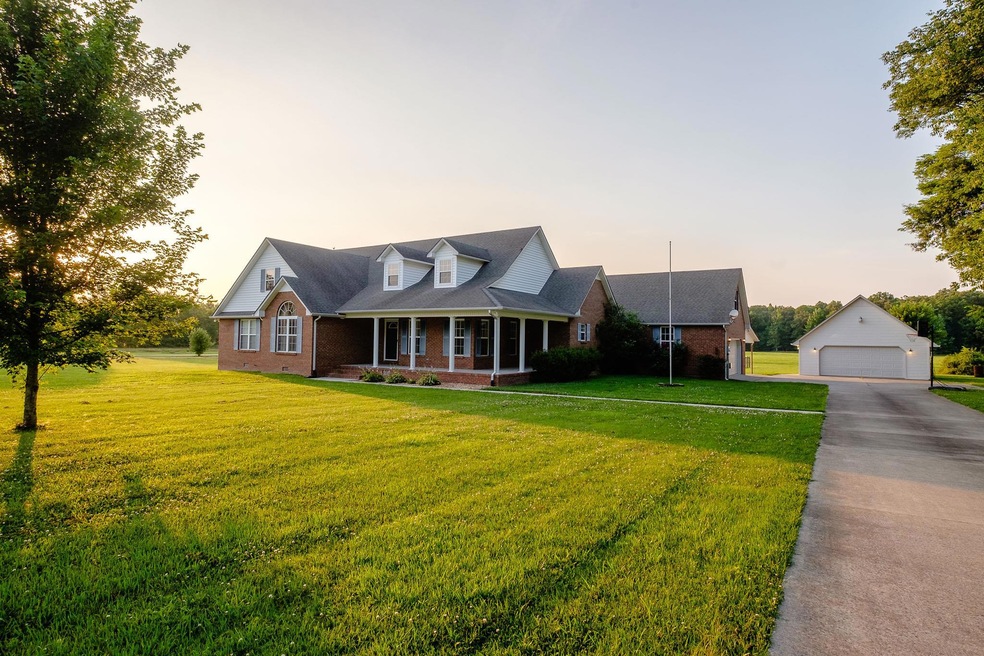 Beautiful custom brick home w/4 BRs/3.5 baths, detached garage & over 2 acres!