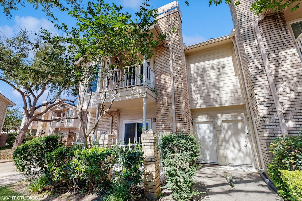 This is a charming townhouse with a brick exterior