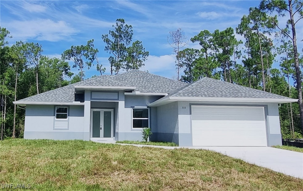 Prairie-style home with a shingled roof, stucco siding, french doors, a front yard, and a garage
