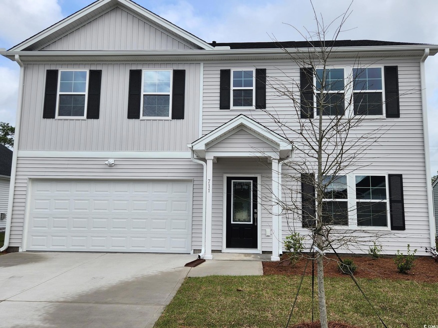 View of front of property featuring an attached ga