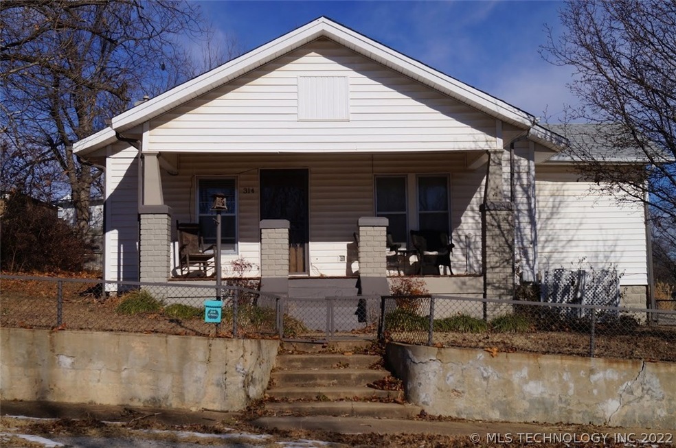 Front view with chain-link fence around front yard