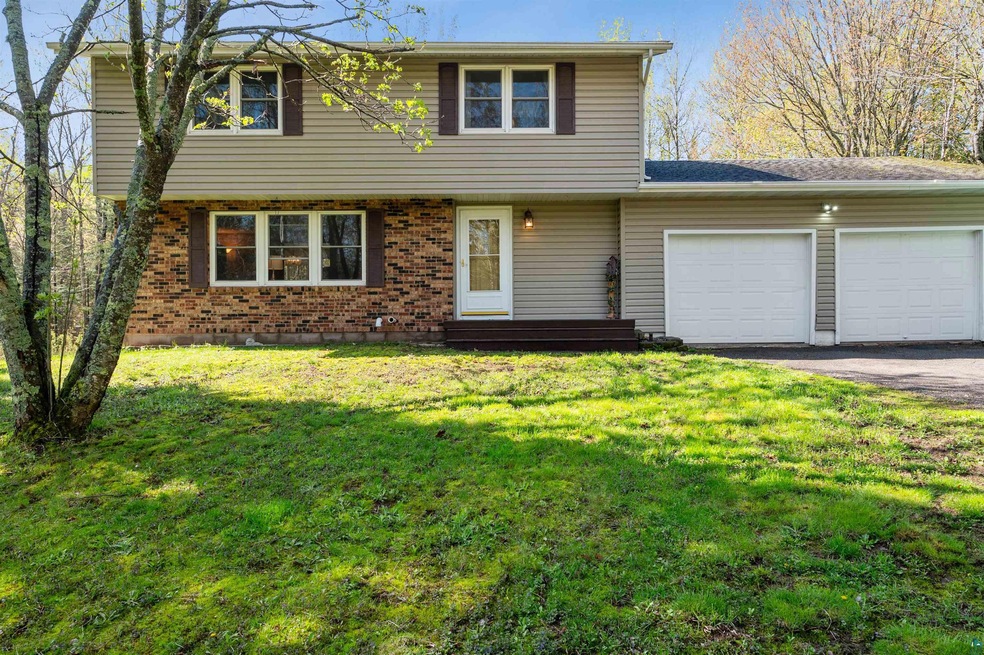 View of front property featuring a garage and a fr