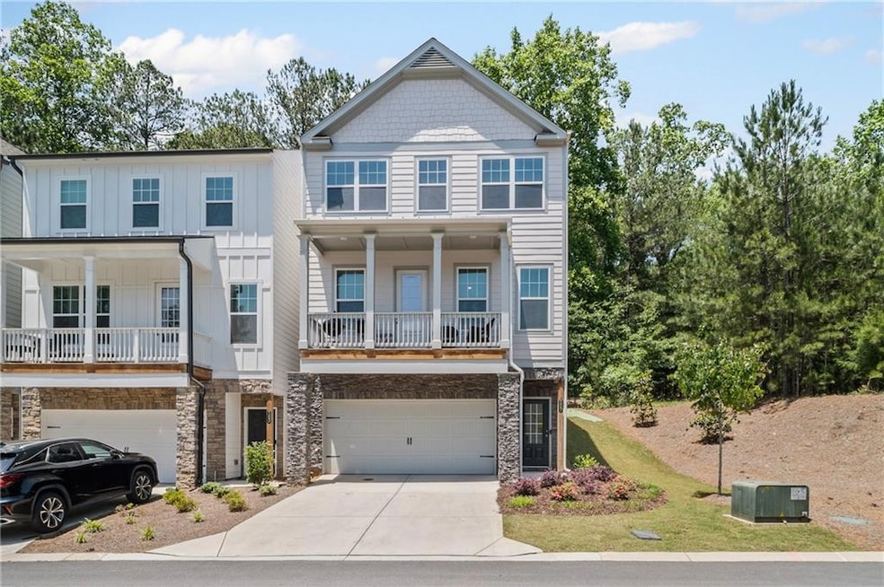 View of front facade featuring a garage, driveway,