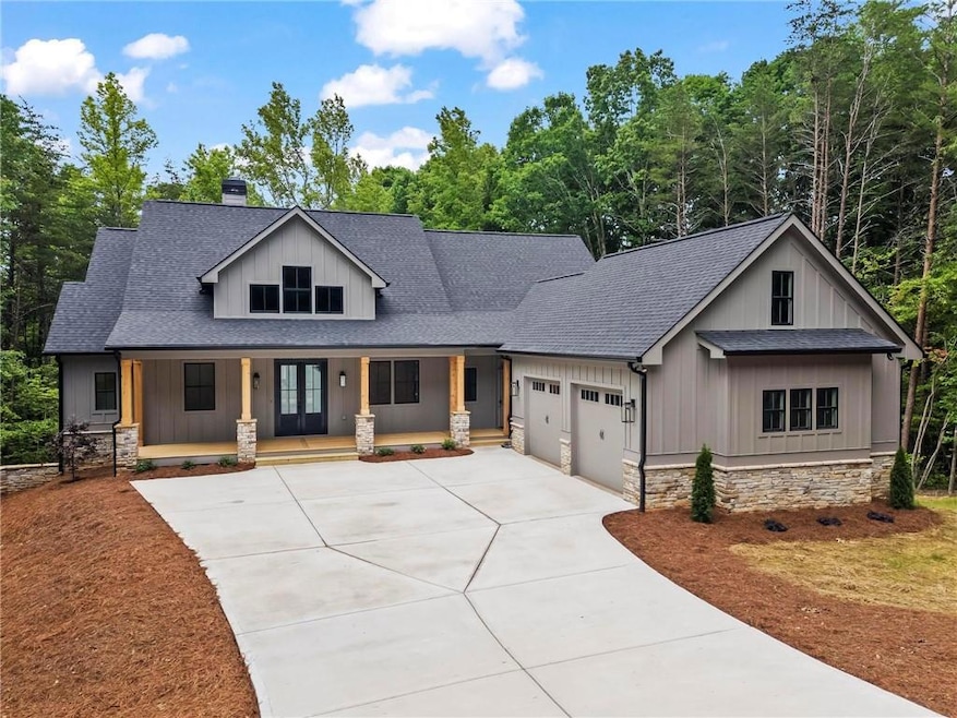 Modern inspired farmhouse featuring a garage and a