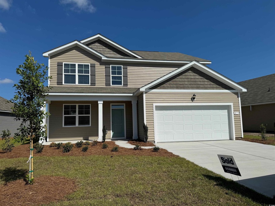 Craftsman house featuring a garage and a front yar
