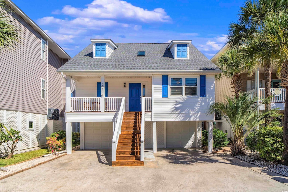 Raised beach house featuring a shingled roof, stairway, a porch, driveway, and an attached garage