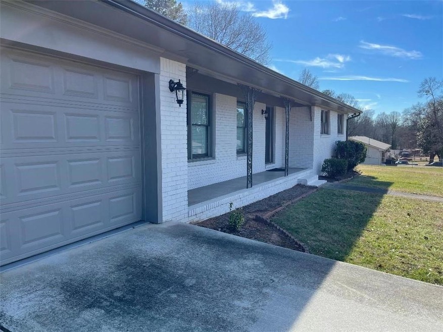 View of home's exterior featuring a yard and a garage