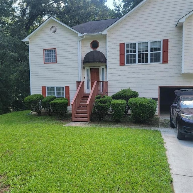 Bi-level home featuring a front lawn