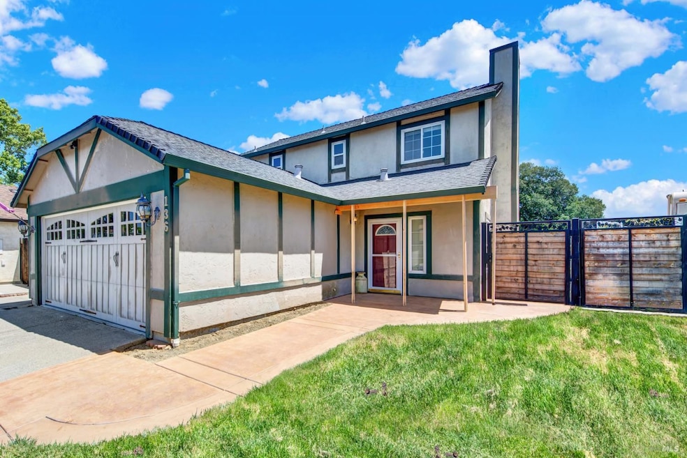 This home as a spacious inner corner lot with paved RV parking with hookup, secured behind a customized gate.  Note the stamped contrete pathway that continues on to a backyard patio.