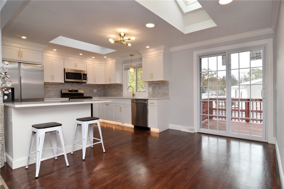 w/dual skylights and Dining Area w/ sliders to dec