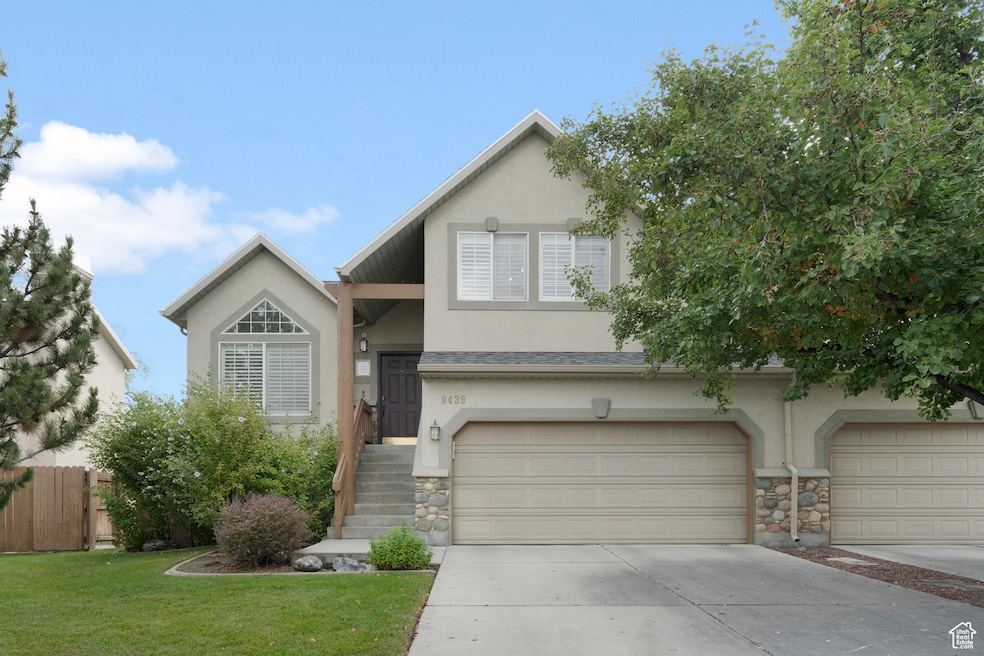 View of front of property featuring stucco siding, stone siding, concrete driveway, and an attached garage