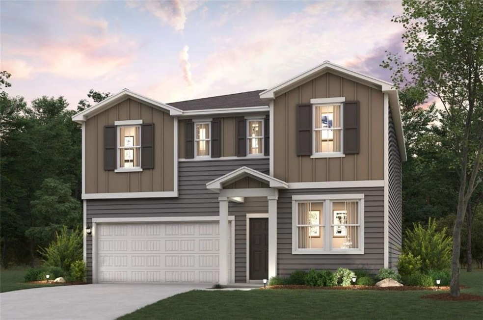 View of front of property with a garage and a yard