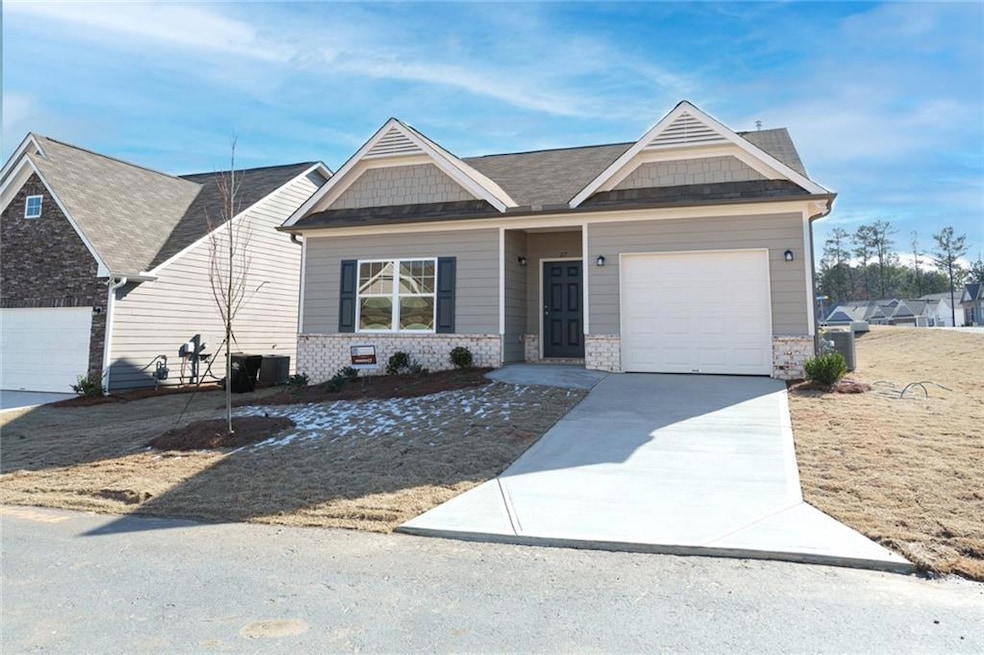 View of front of home featuring concrete driveway and a garage