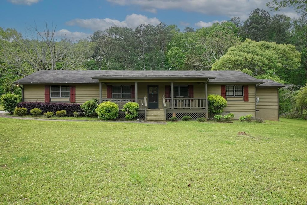 Single story home with a front lawn and a porch
