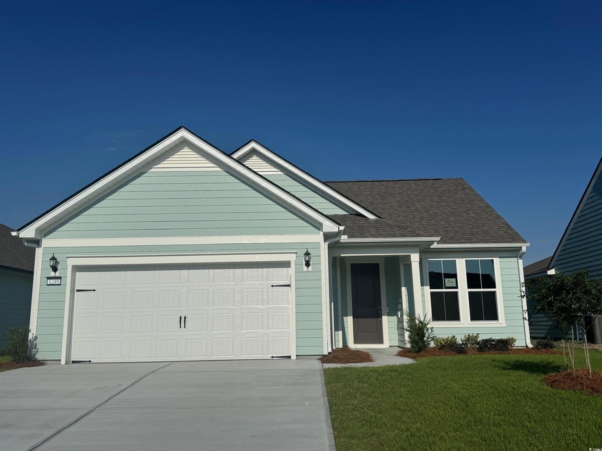 Ranch-style home with roof with shingles, a front 