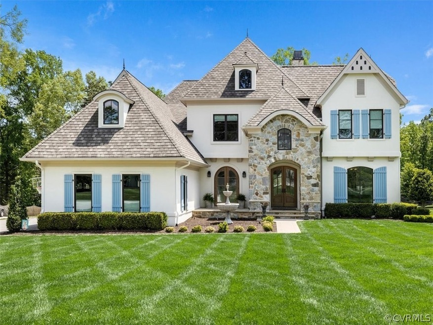 Stucco exterior with stone entry and front terrace