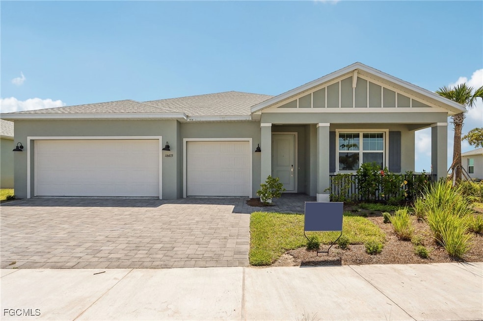 View of front of home with decorative driveway, covered porch, an attached garage, stucco siding, and board and batten siding