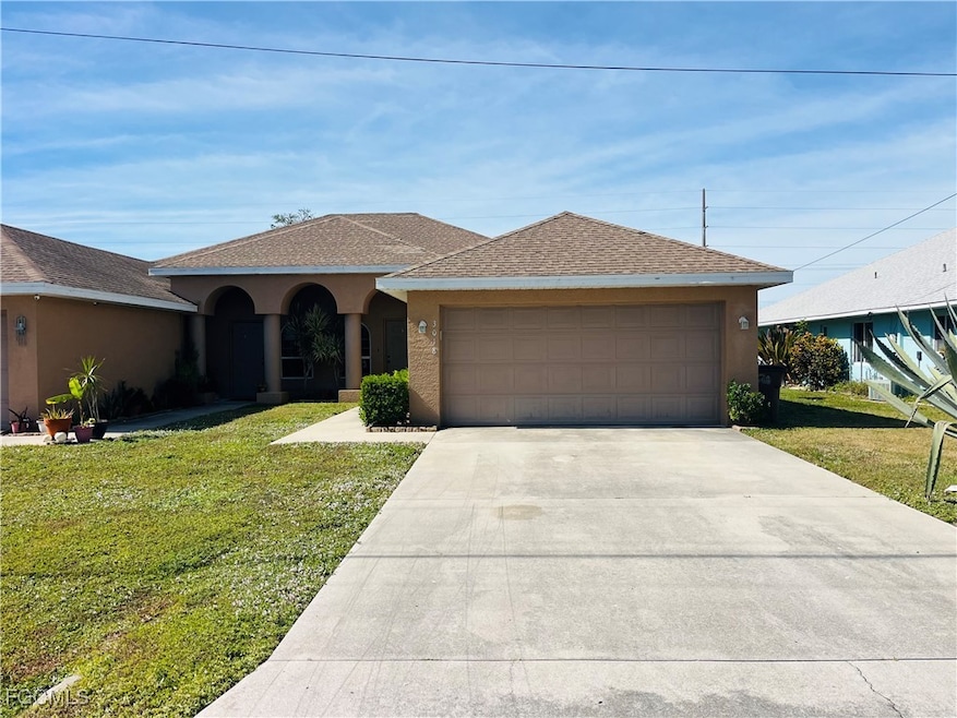 View of front facade with roof with shingles, stucco siding, a front yard, and concrete driveway