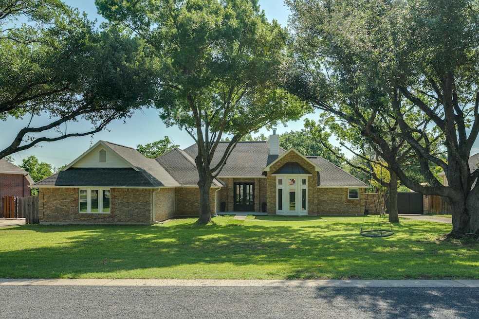 View of front of house featuring french doors, br