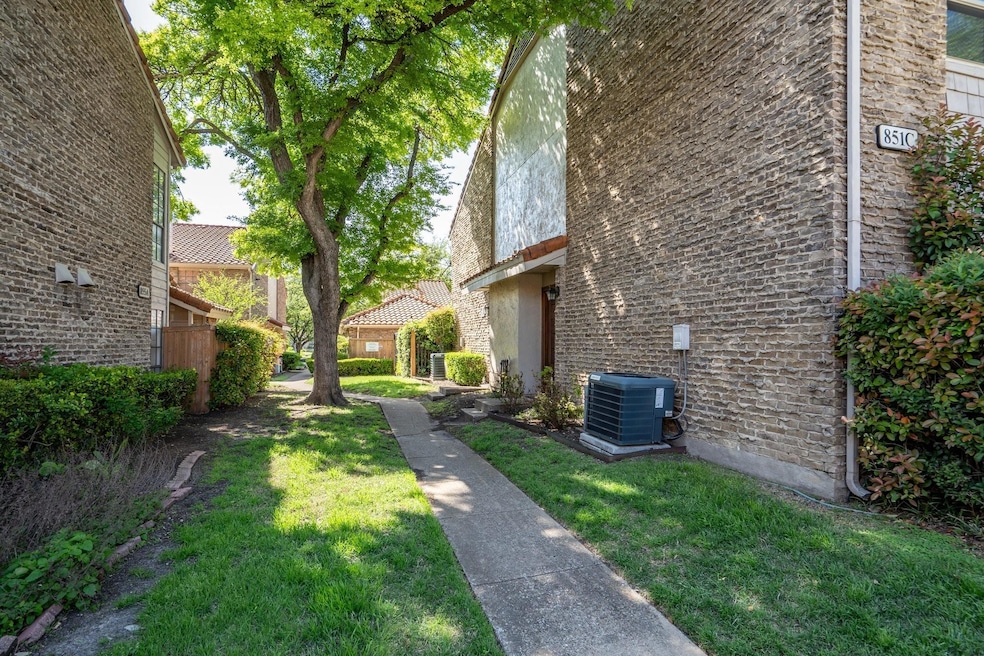 View of property exterior with a yard, central AC,