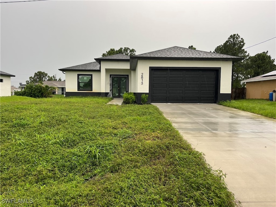 Prairie-style house with stucco siding, concrete d