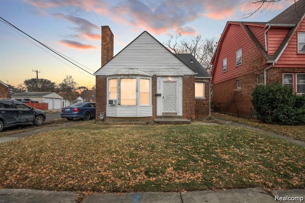 Bungalow-style house featuring a front yard, a chimney, and brick siding