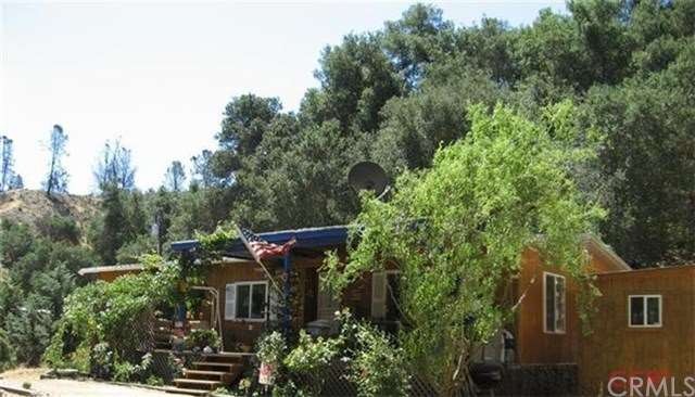 Comfortable home on 10+ acres with a deck, covered