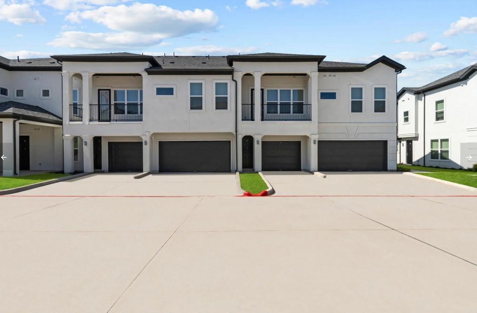 View of property with a garage, stucco siding, dr
