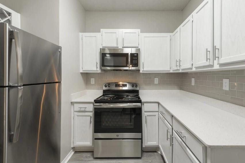 Kitchen featuring tasteful backsplash, light hardw