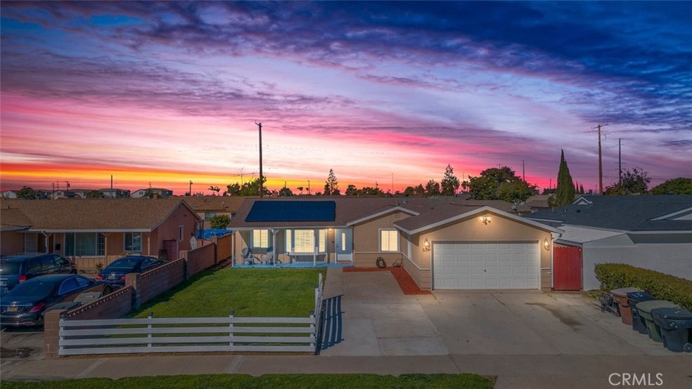 Twilight charm of a quaint suburban home, glowing under a vibrant sunset sky.