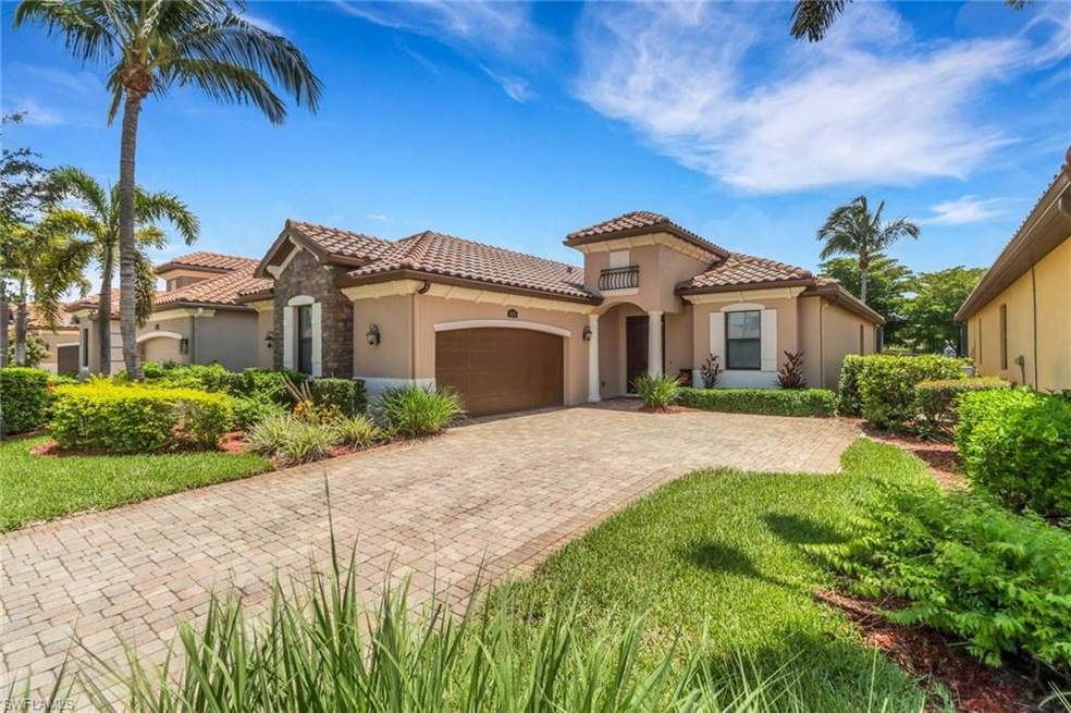 Mediterranean / spanish-style home featuring stucco siding, a garage, a tiled roof, and driveway