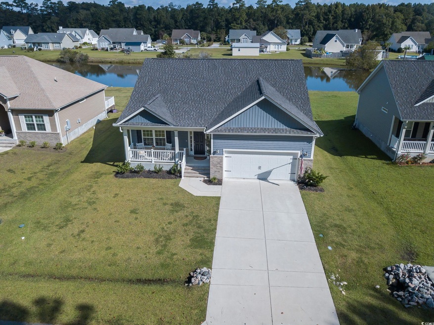 View of front facade with a porch, a front lawn, a