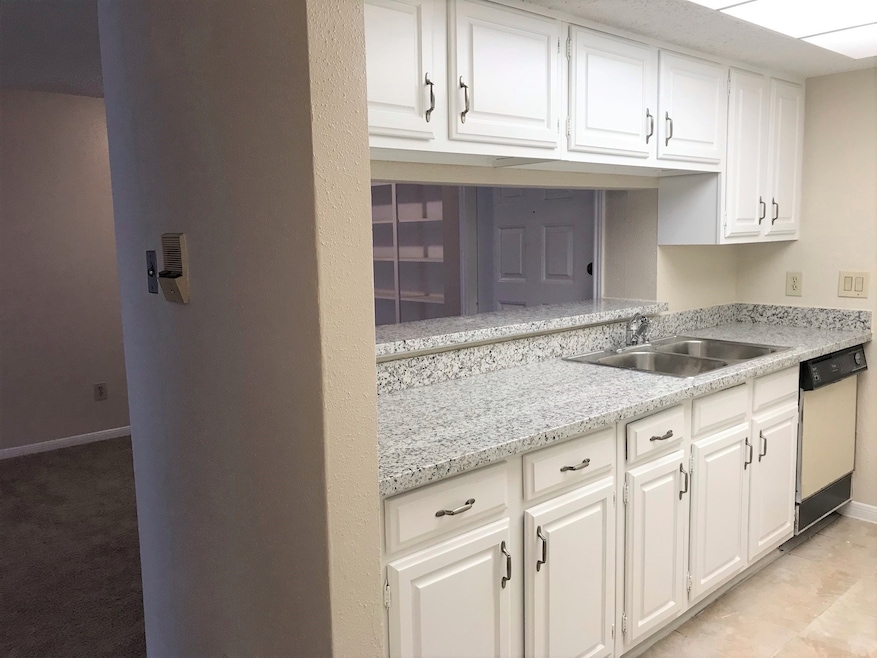 Kitchen open to living/dining room. Has granite co