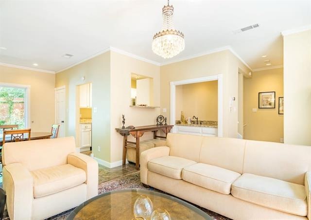 Open living and dining areas with a wet bar