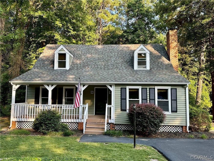 New England style Cape Cod home with a porch
