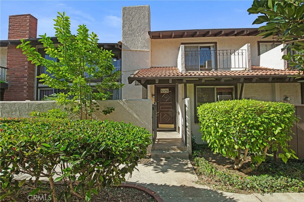 Front Entry with enclosed patio and balcony above.