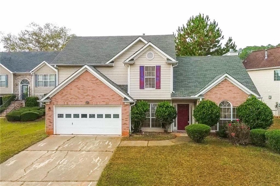 Front of property with a front lawn and a garage