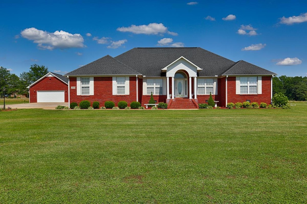 Front View of Home - Spectacular one owner home with amazing curb appeal.  The lovely front stoop is highlighted by 4 columns plus the arch topped front door with side lights.  Notice the lush landscaping.