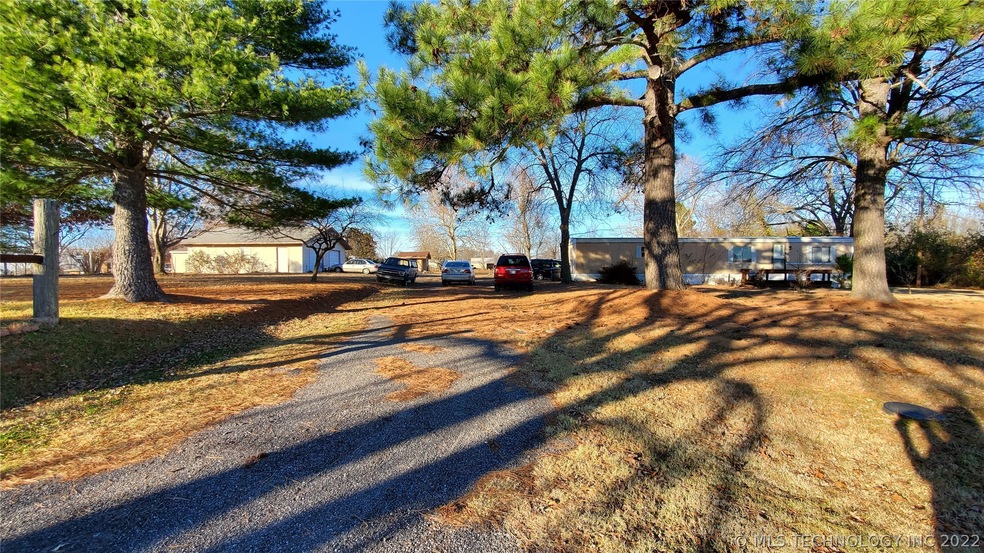 Front of property from 56th St. showing older mobi