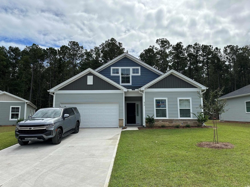 Craftsman house featuring a garage and a front law