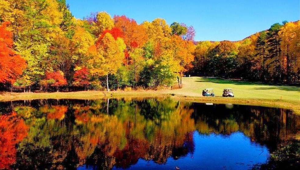 View of community featuring lake and golf course v