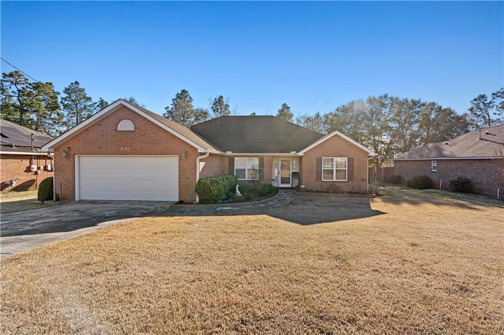 Single story home featuring a garage and a front l
