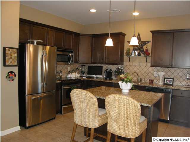 Large Open Kitchen with Granite, Tumbled Stone Back Splash/ Stainless Appliances and Island for food prep or social gathering.