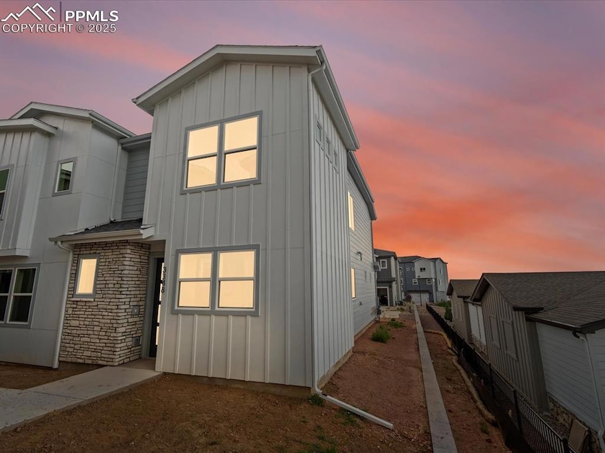 View of front of home with board and batten siding and stone siding
