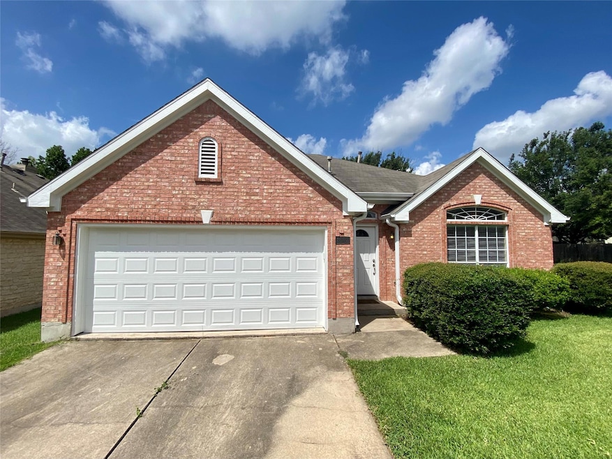 Ranch-style home with concrete driveway, brick siding, and a garage
