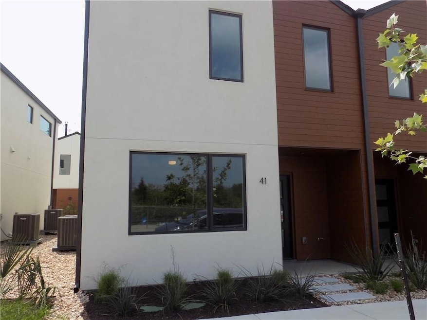 View of front facade with stucco siding and cooli