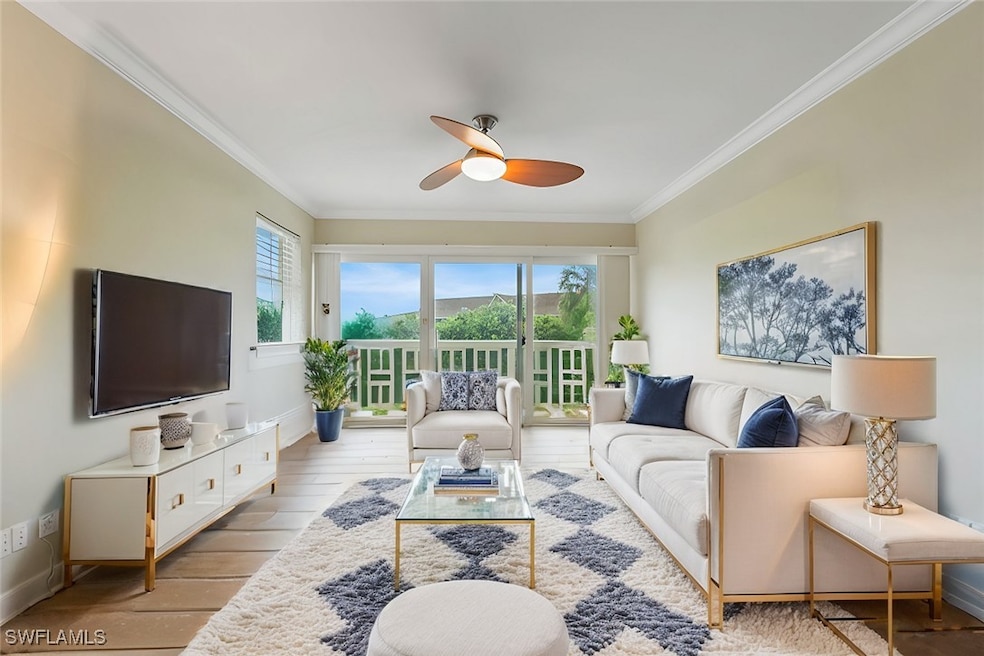 Living area featuring crown molding, a ceiling fan, and hardwood / wood-style floors