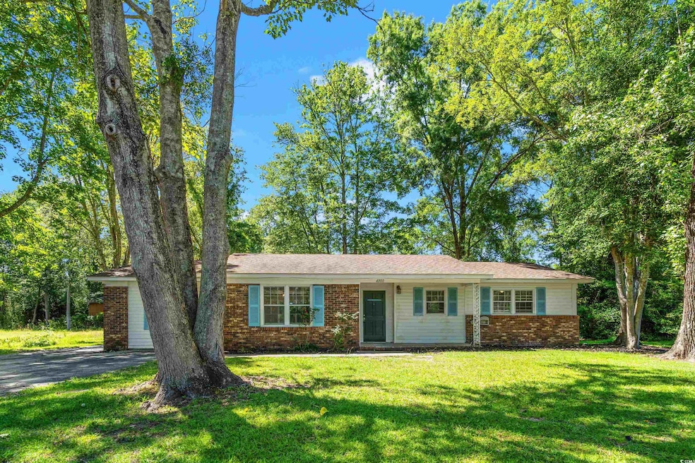 Ranch-style house featuring brick siding, a front yard, and driveway
